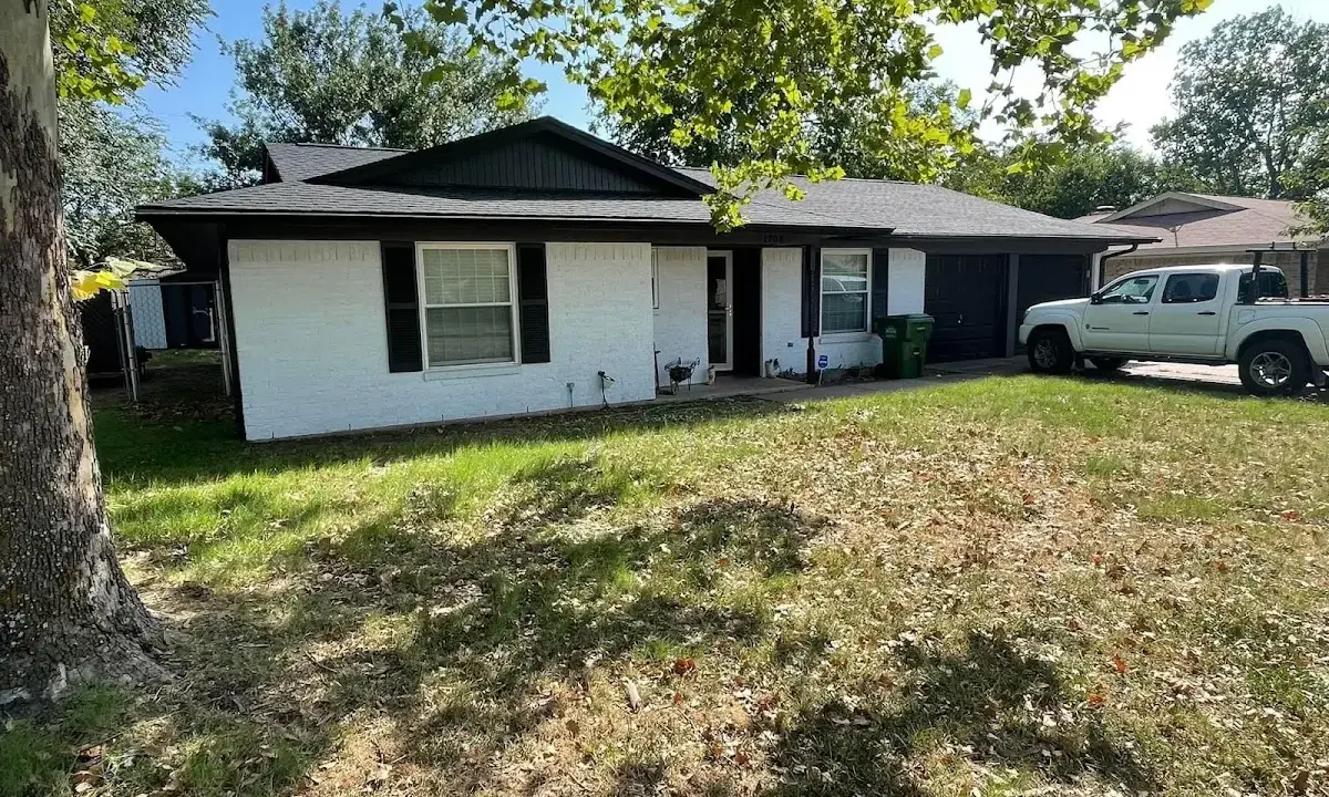 Professional roofing crew working on a residential roof in Colby